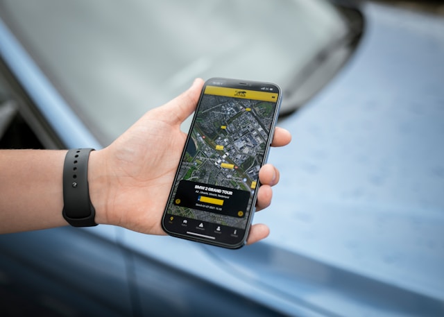 A person holding a mobile device and looking at a map. 