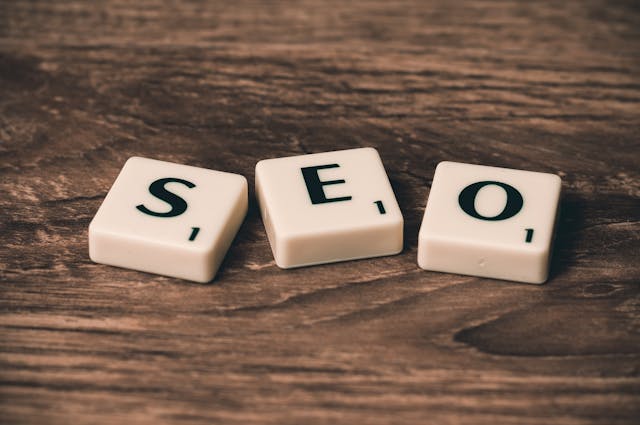 pexels-pixabay-270637 2 - GeoPlugin - Resources The acronym “SEO” with tiles on a wooden table.
