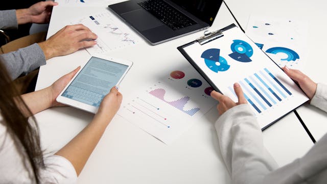pexels-artempodrez-5716032 - GeoPlugin - Resources People working with analytics data around a table.
